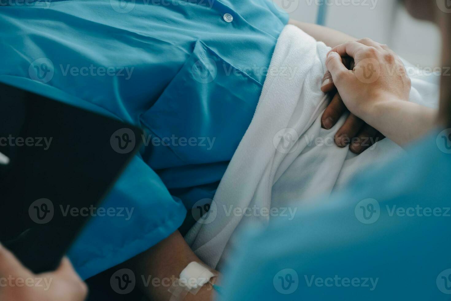 Injured patient showing doctor broken wrist and arm with bandage in hospital office or emergency room. Sprain, stress fracture or repetitive strain injury in hand. Nurse helping customer. First aid. photo