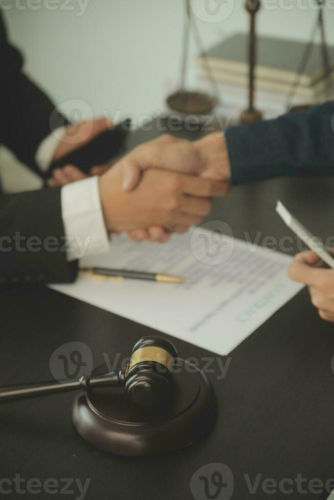 Lawyer, legal advisor, businessman brainstorming information on agreement details Business contracts in legal processing books for accuracy in contract documents. joint financial investment. photo