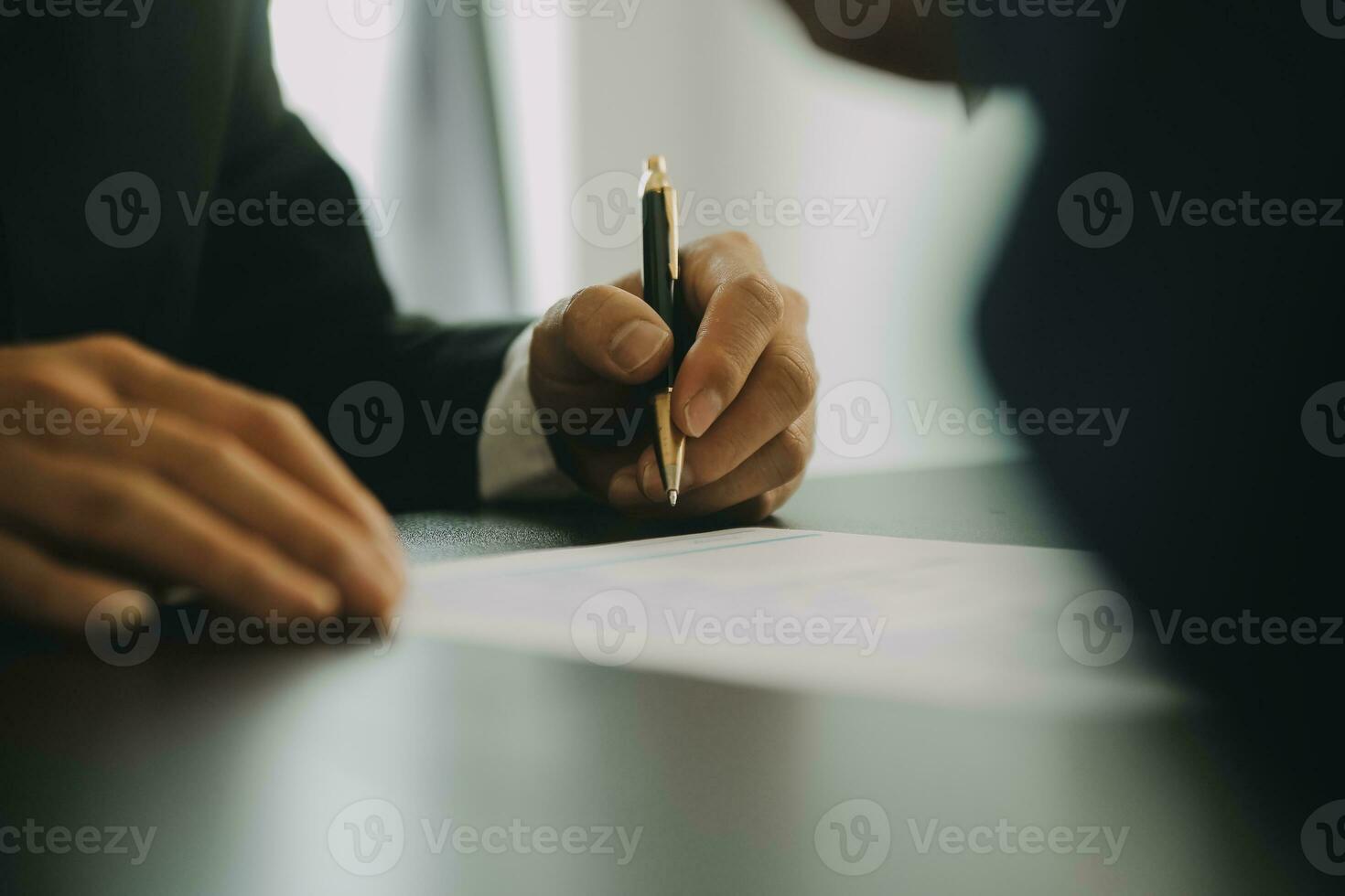 Justice and Law concept. Legal counsel presents to the client a signed contract with gavel and legal law or legal having team meeting at law firm in background photo