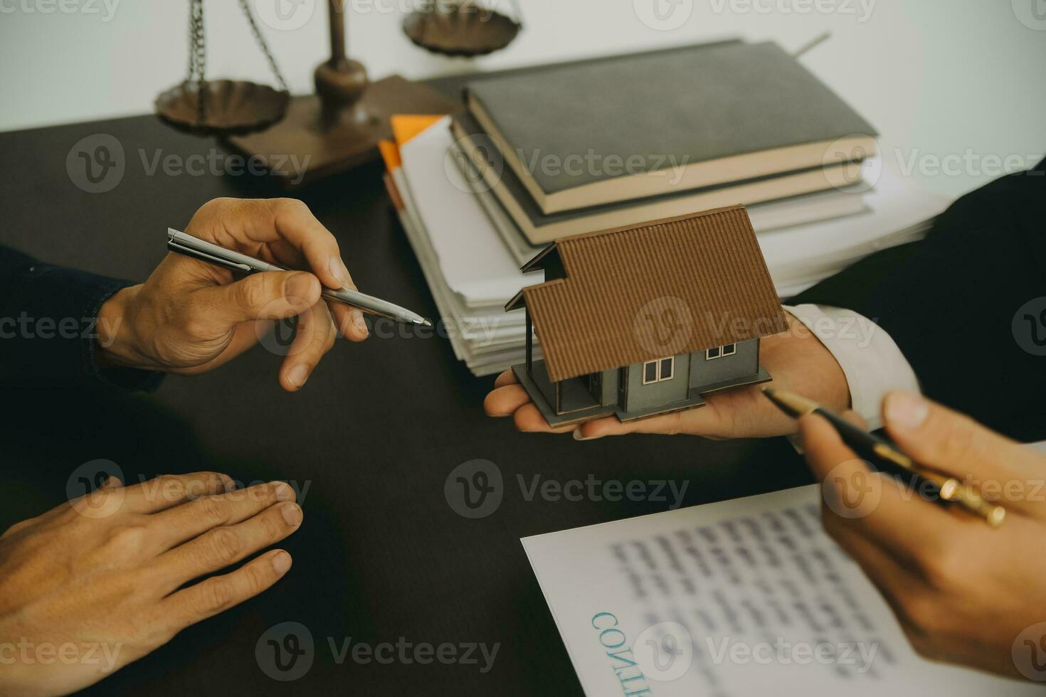 Justice and Law concept. Legal counsel presents to the client a signed contract with gavel and legal law or legal having team meeting at law firm in background photo