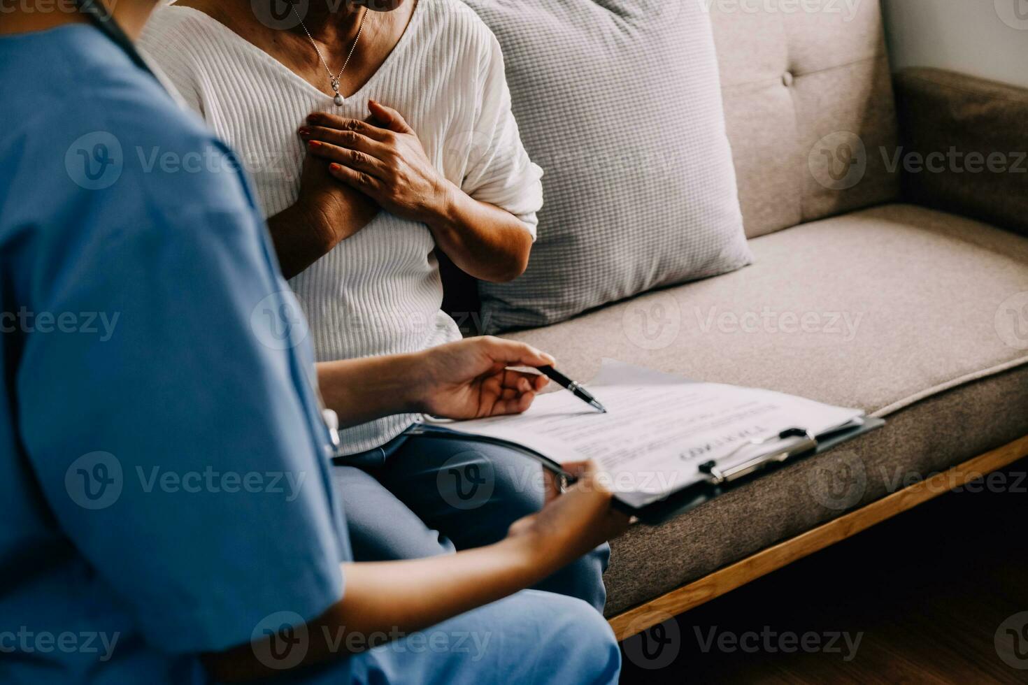 Caring doctor teaches female patient to use mobile healthcare app. Retired lady sitting in hospital exam room looking at cell screen learning to download health tracker for senior citizens. Copy space photo