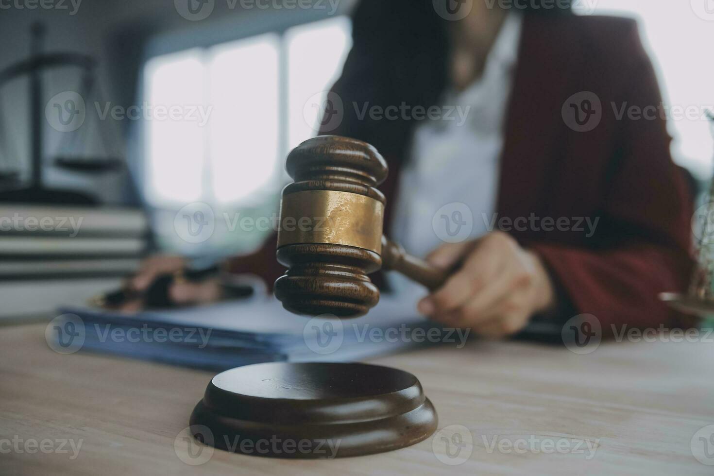 Business and lawyers discussing contract papers with brass scale on desk in office. Law, legal services, advice, justice and law concept picture with film grain effect photo
