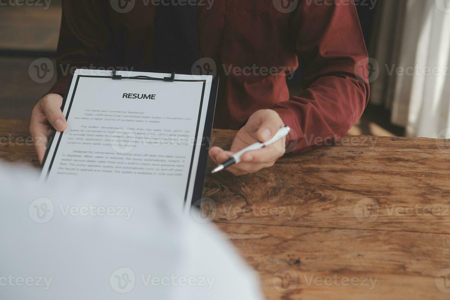 Close up view of job interview in office, focus on resume writing tips, employer reviewing good cv of prepared skilled applicant, recruiter considering application, hr manager making hiring decision photo