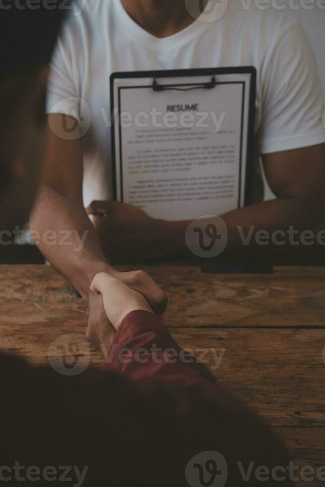 Close up view of job interview in office, focus on resume writing tips, employer reviewing good cv of prepared skilled applicant, recruiter considering application, hr manager making hiring decision photo