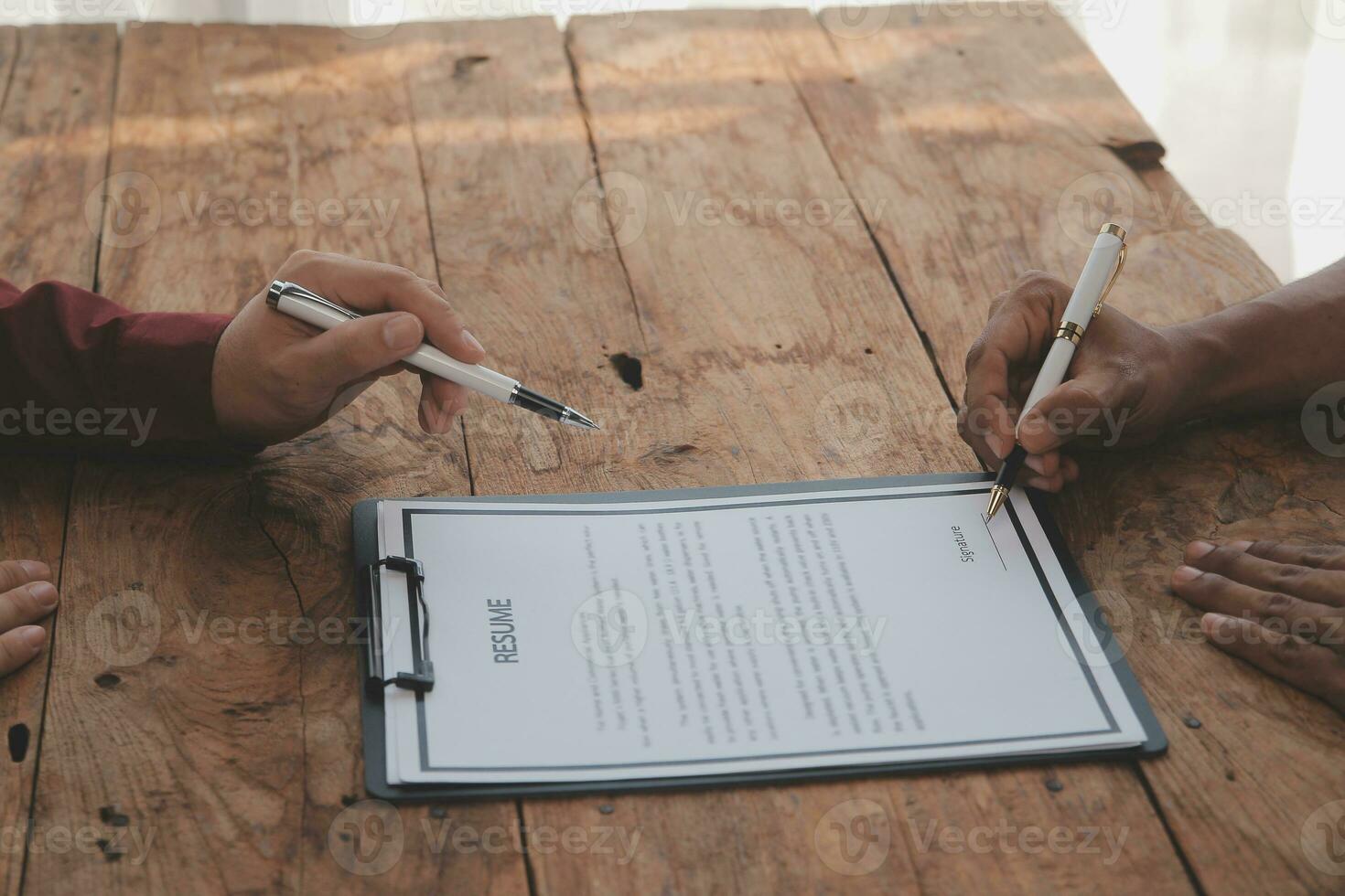 Close up view of job interview in office, focus on resume writing tips, employer reviewing good cv of prepared skilled applicant, recruiter considering application, hr manager making hiring decision photo