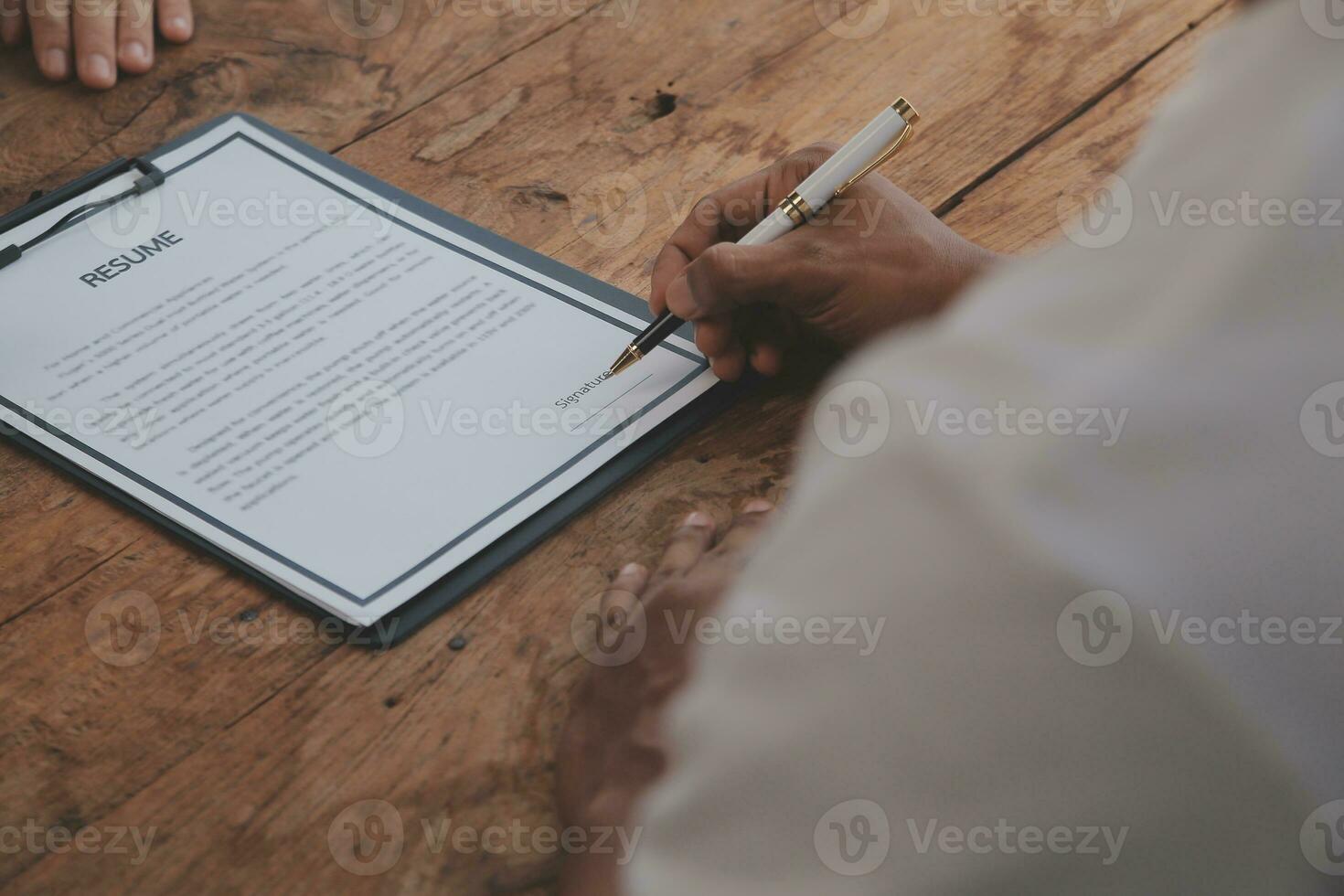 Close up view of job interview in office, focus on resume writing tips, employer reviewing good cv of prepared skilled applicant, recruiter considering application, hr manager making hiring decision photo
