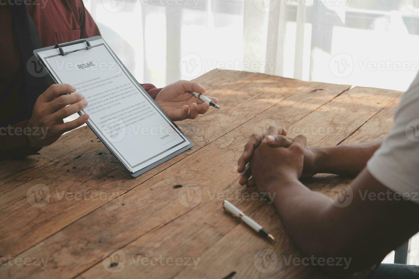 Close up view of job interview in office, focus on resume writing tips, employer reviewing good cv of prepared skilled applicant, recruiter considering application, hr manager making hiring decision photo