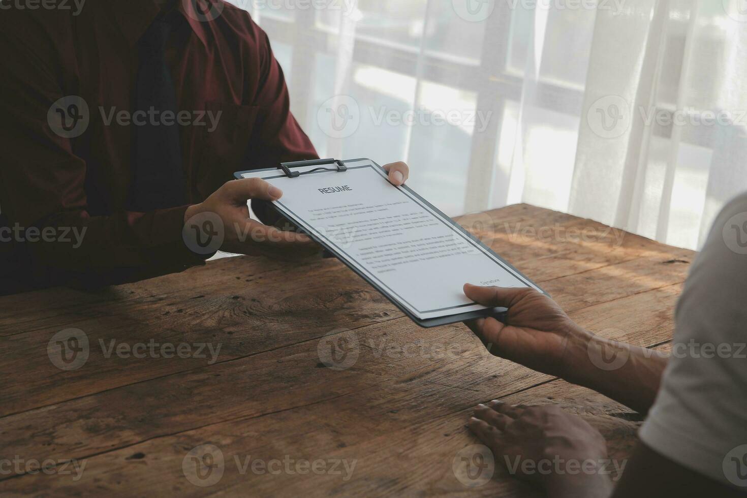 Close up view of job interview in office, focus on resume writing tips, employer reviewing good cv of prepared skilled applicant, recruiter considering application, hr manager making hiring decision photo