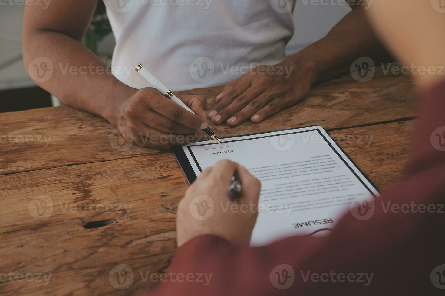 Close up view of job interview in office, focus on resume writing tips, employer reviewing good cv of prepared skilled applicant, recruiter considering application, hr manager making hiring decision photo