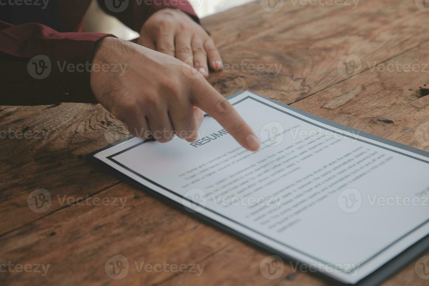 Close up view of job interview in office, focus on resume writing tips, employer reviewing good cv of prepared skilled applicant, recruiter considering application, hr manager making hiring decision photo