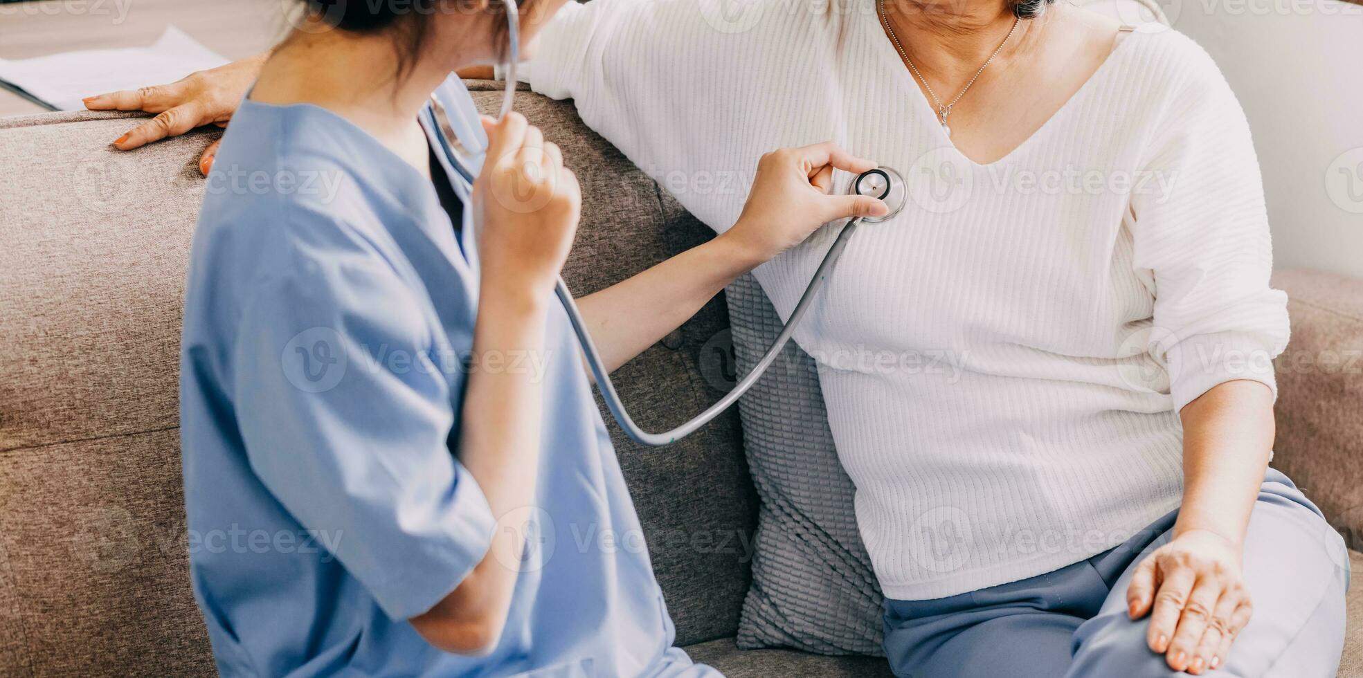 Doctor use stethoscope, checking up heart beat, lunch of auscultation in doctor office at hospital. Patient worker has to get medical checkup every year for her health or medical checkup cardiologist photo