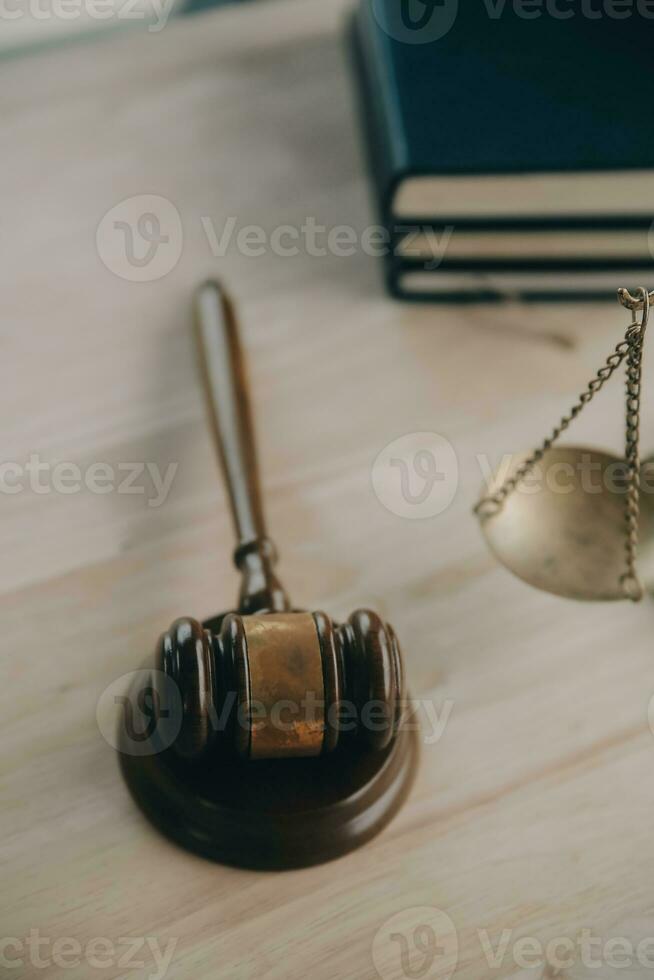 Justice and law concept.Male judge in a courtroom with the gavel, working with, computer and docking keyboard, eyeglasses, on table in morning light photo