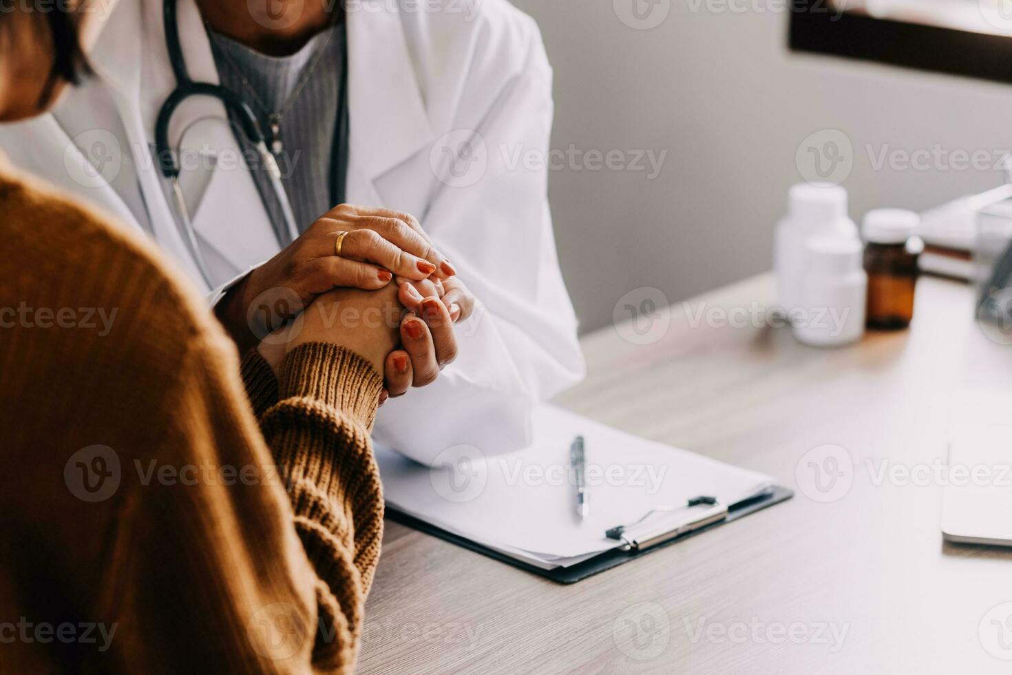 Young psychologist holding hand of her patient in need while consulting her after discussion of problem photo