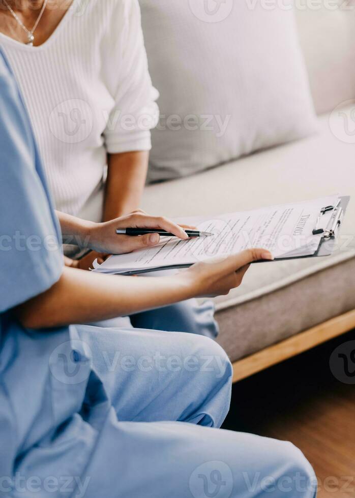 Serious GP doctor showing tablet screen to old 70s female patient, explaining electronic prescription, medical screening, examination result, giving consultation. Woman visiting practitioner photo