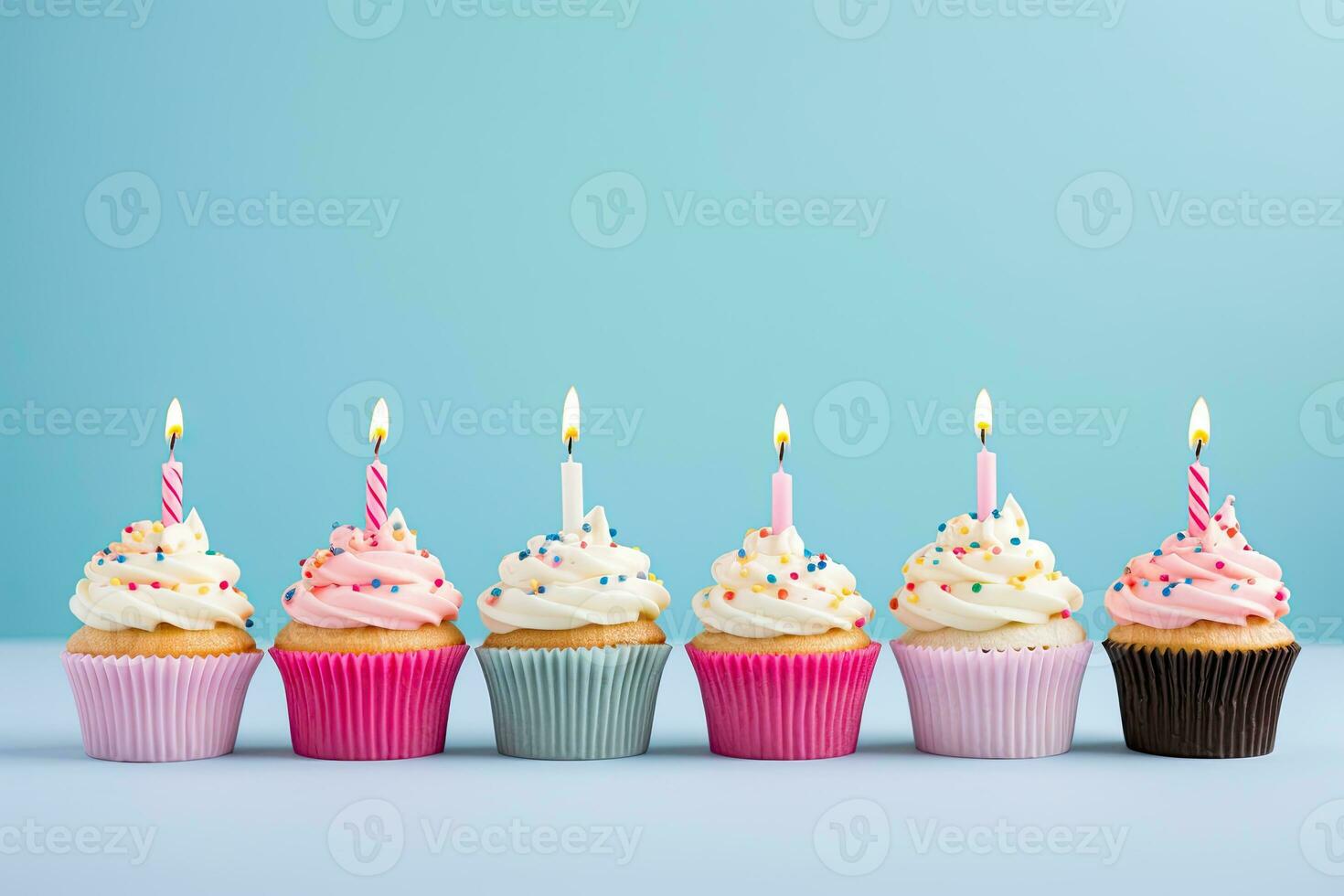 Generative AI, Row of colorful birthday cupcakes with candle of each, on light pink background photo