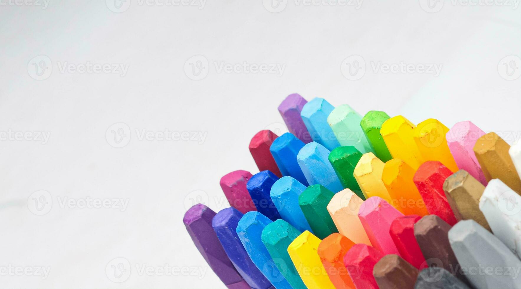 a group of crayon sticks arranged neatly visible at the tip of the pencil photo