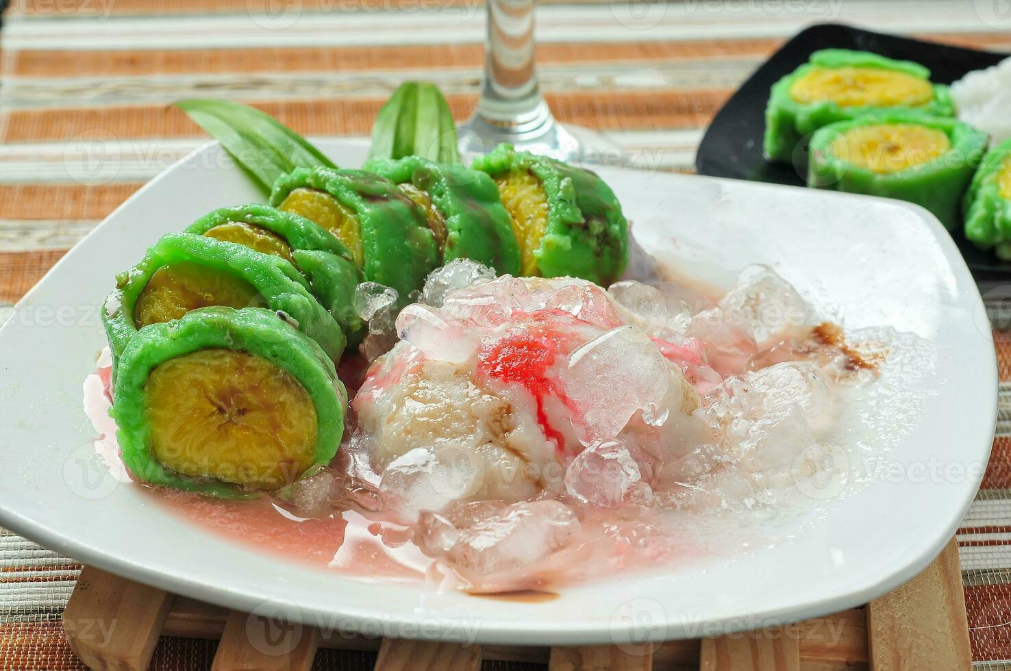 Es Pisang Ijo, traditional dessert from Makassar, South Sulawesi, Indonesia, made from banana which is rolled with a mixture of wheat flour, rice flour and coconut milk. Served with pureed and syrup photo