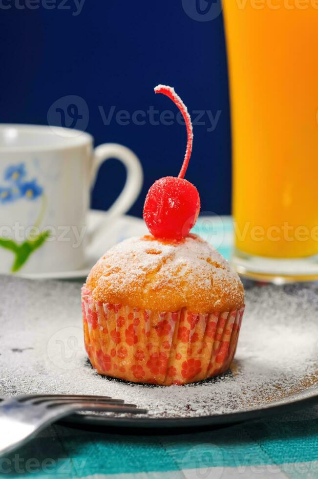 Cupcake cherry in blue background photo