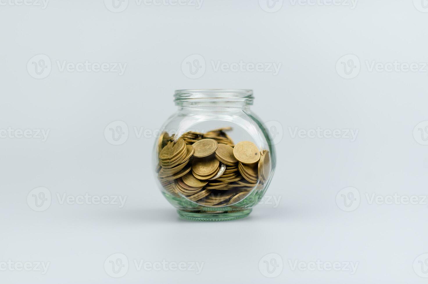 Saving coins in a glass jar, coin bank, financial investments, income, wages, mutual funds, cash flow, financial growth, investors photo