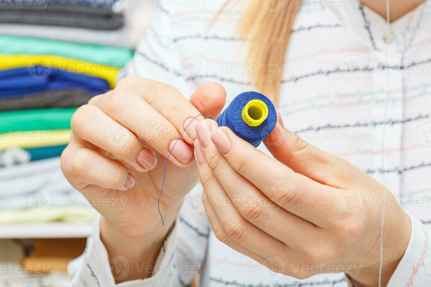 Adjusting the sewing machine, threads in female hands photo