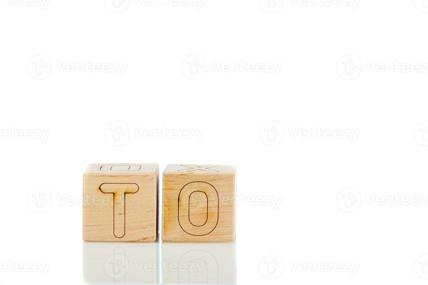 Wooden cubes with letters to on a white background photo