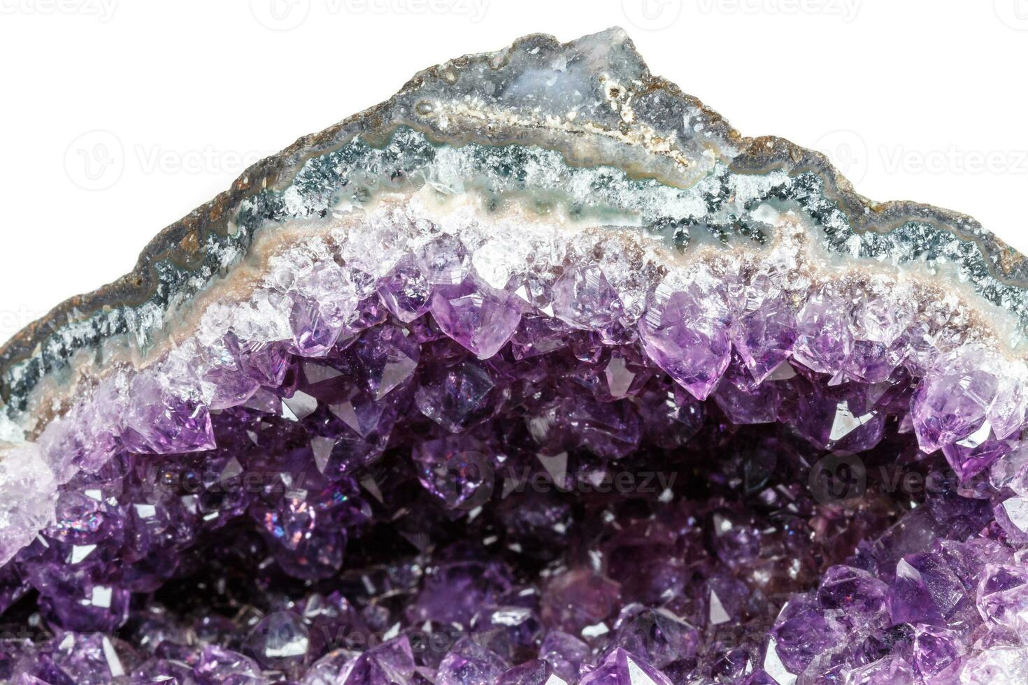Macro Mineral Stone Amethysts in the rock on a white background photo