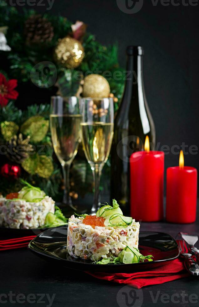 Christmas table setting. Traditional Russian salad Olivier. New Year salad. Festive salad. photo
