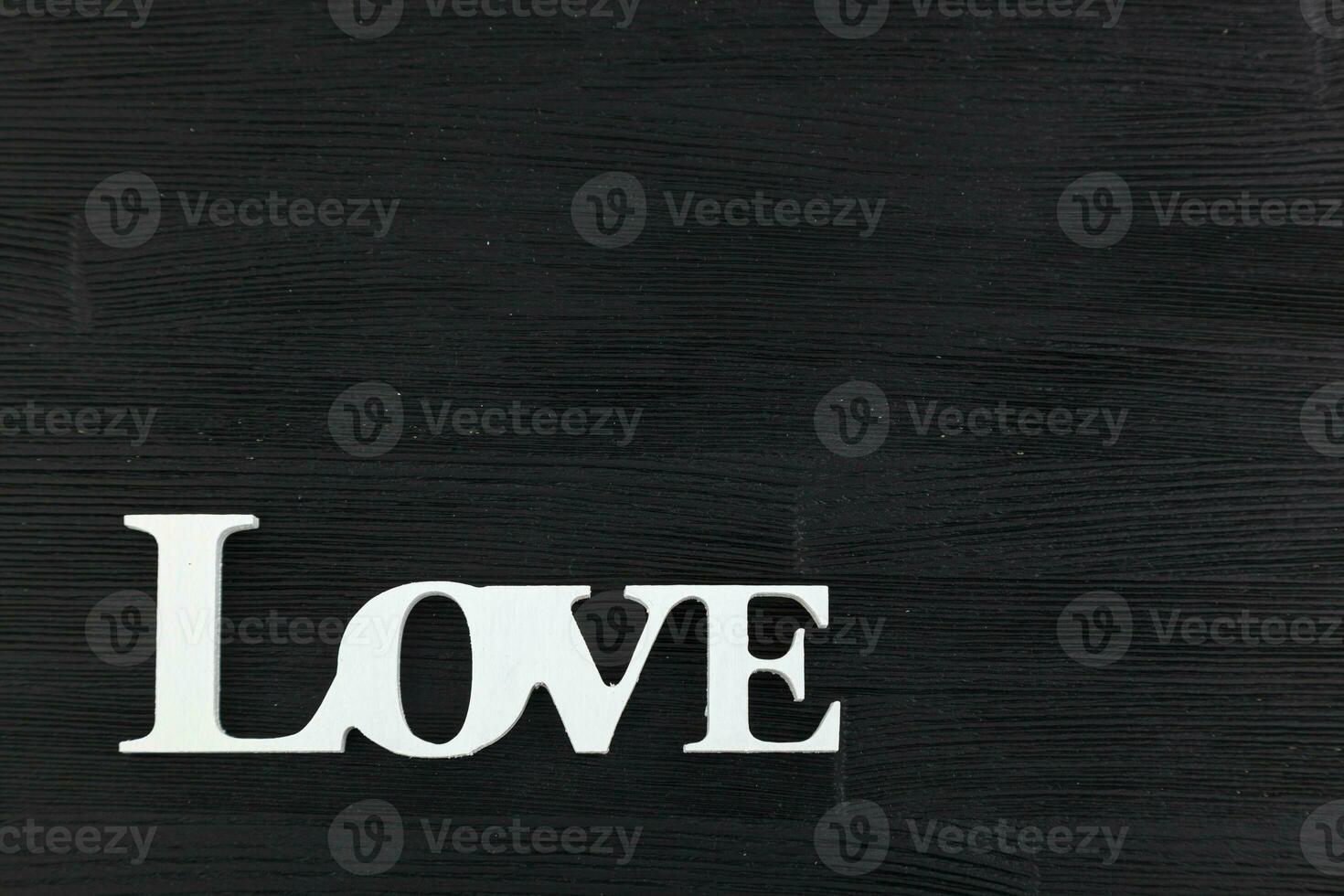 inscription I love you on a black wooden background photo