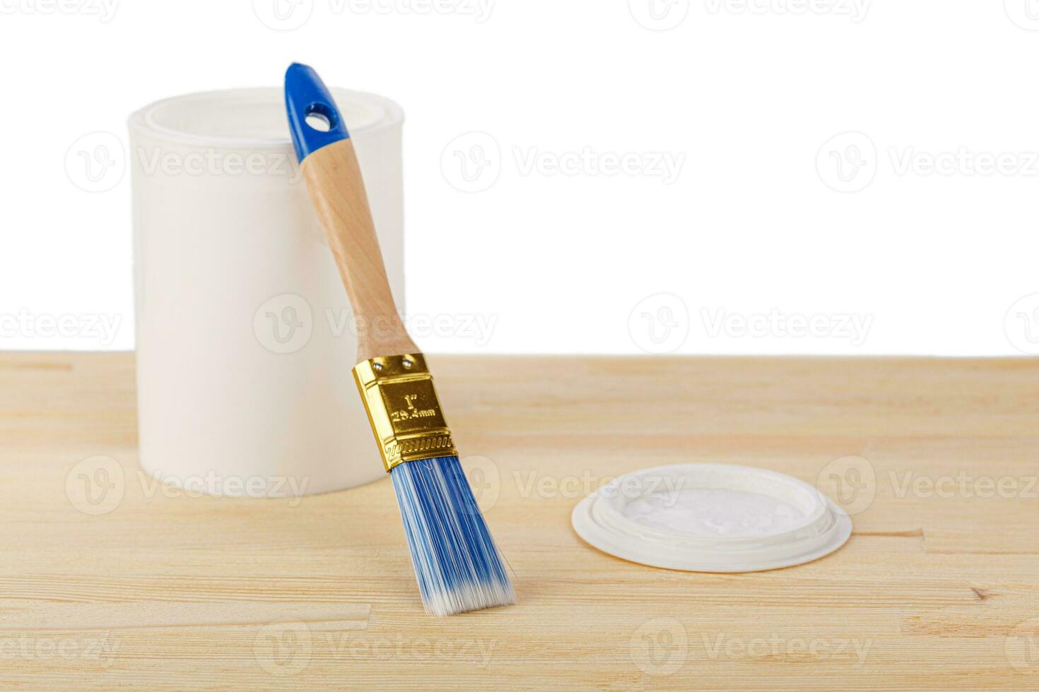 white paint with a brush on a wooden background with texture photo