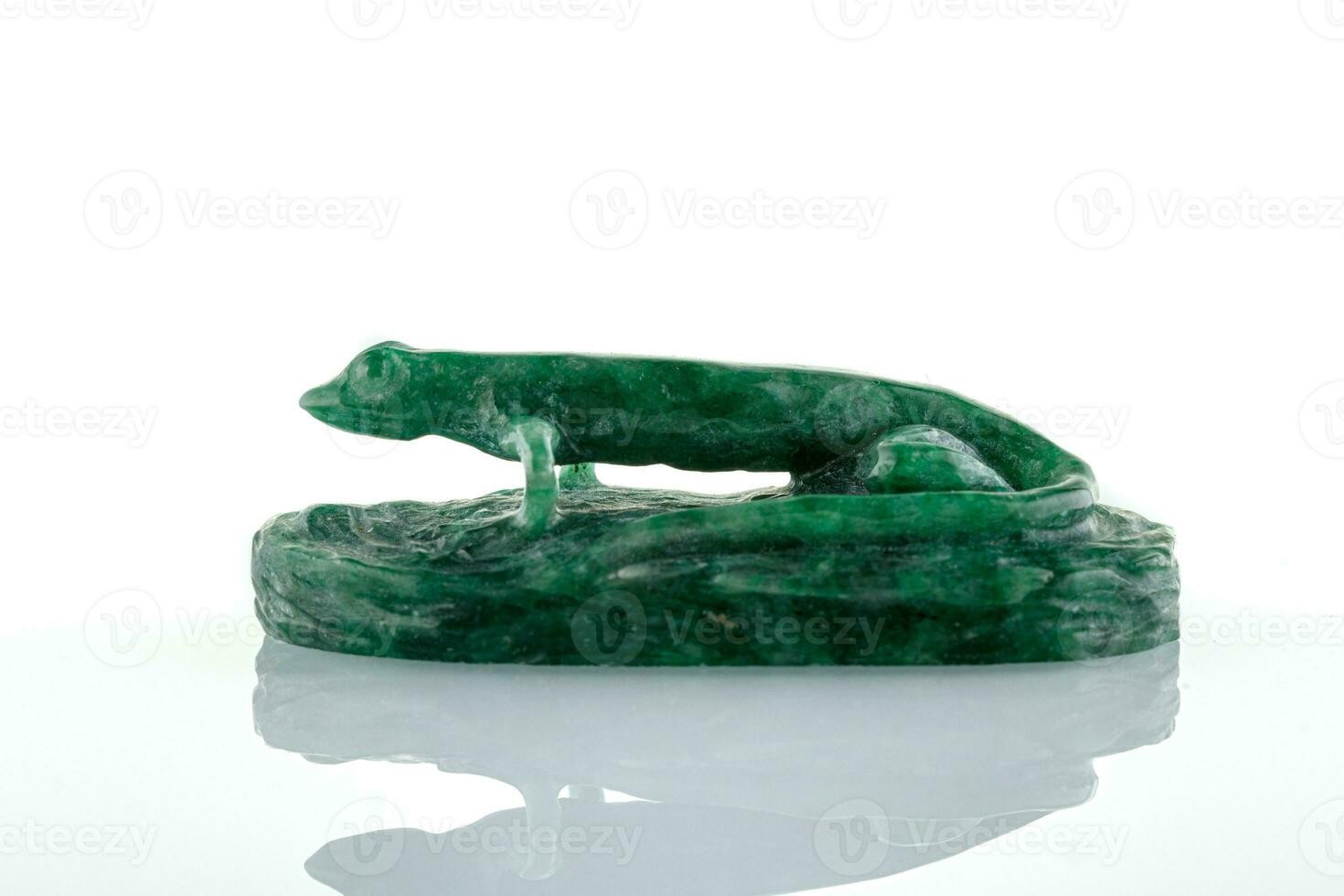 beautiful statuette of lizard salamander from malachite on a white background photo