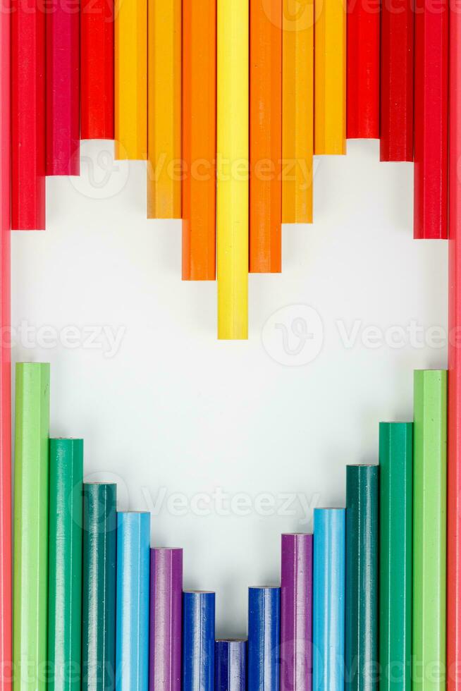 Multicolored pencils in the form of a heart photo