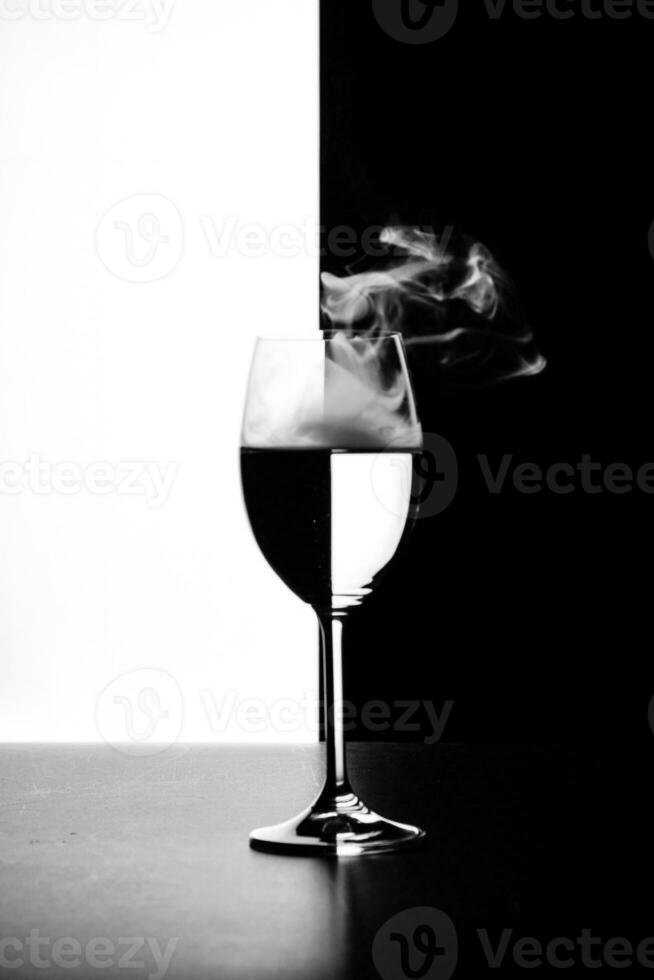 a glass of water and smoke on a black and white background photo