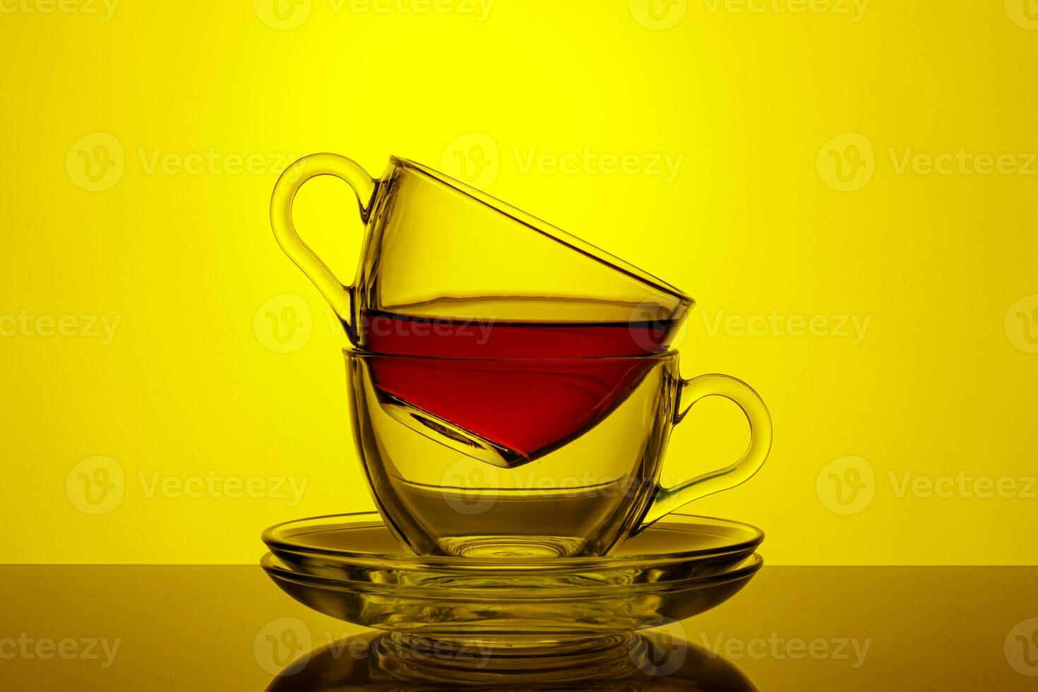 beautiful two cups with tea on a yellow background photo