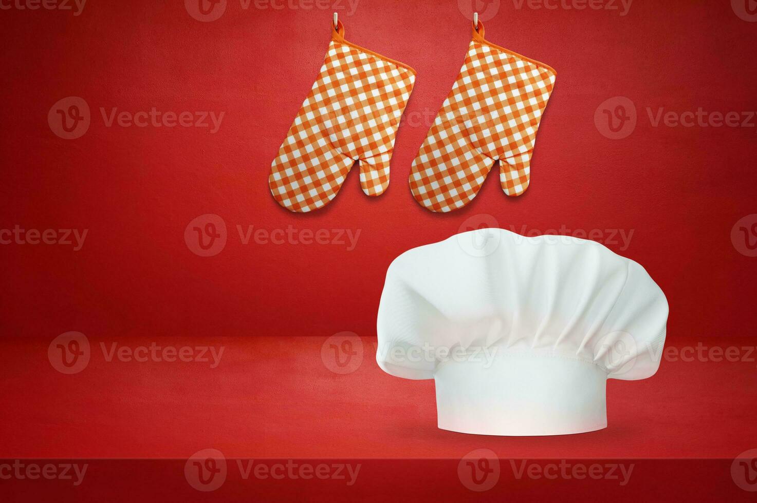 White chef hat and gloves on red background and wall photo