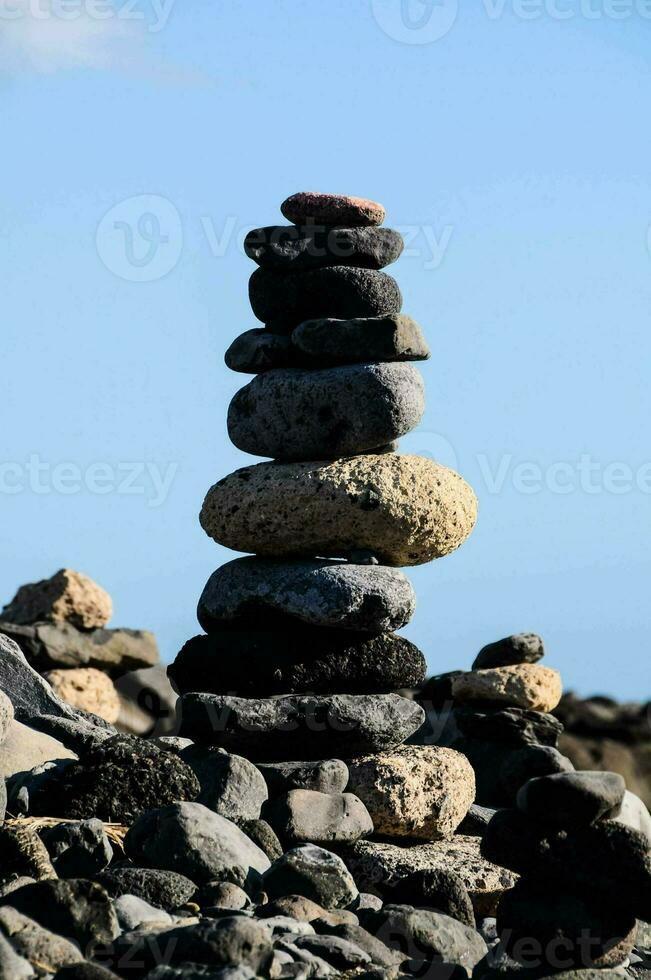 a stack of rocks on a rocky beach photo