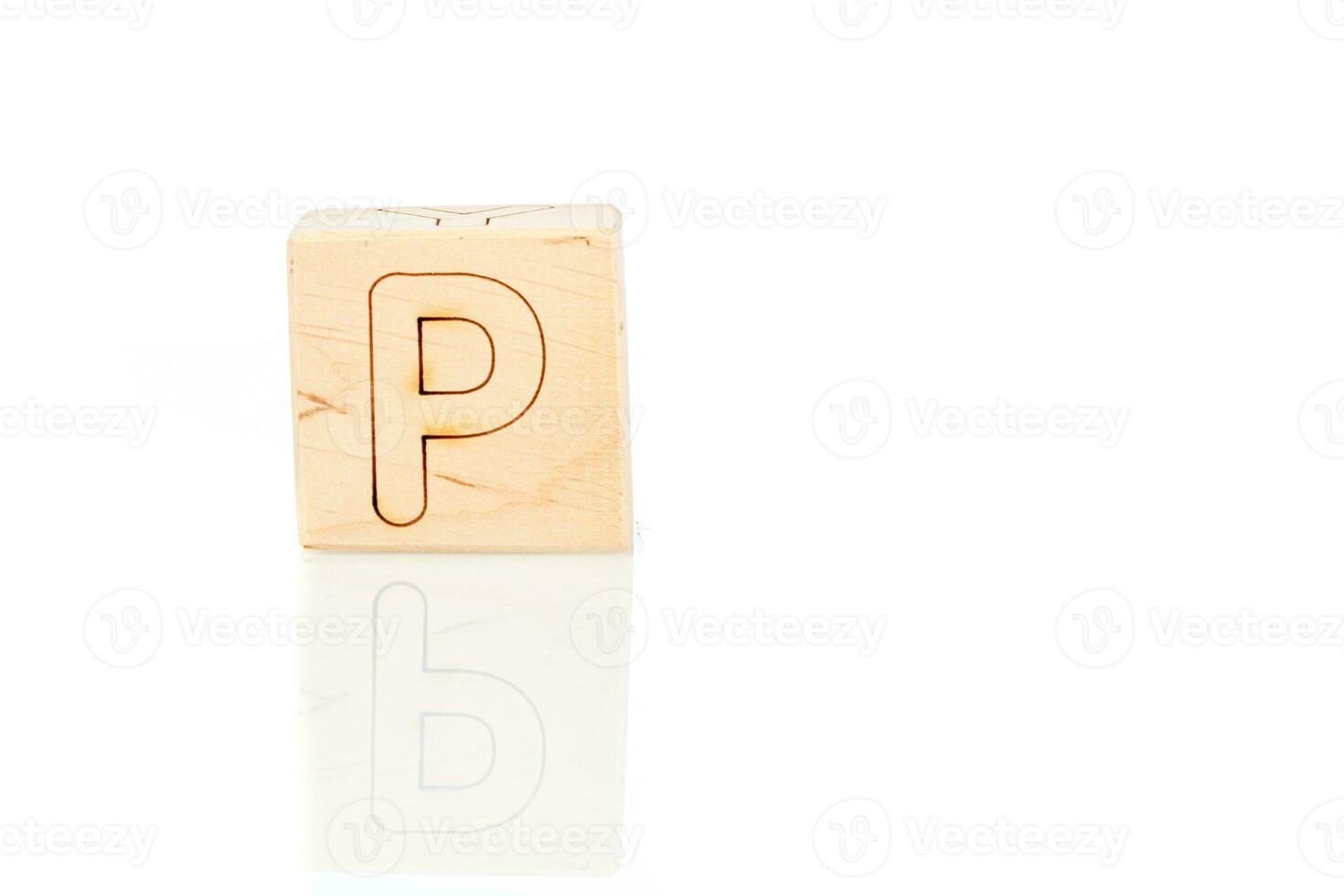 Wooden cubes with letters P on a white background photo