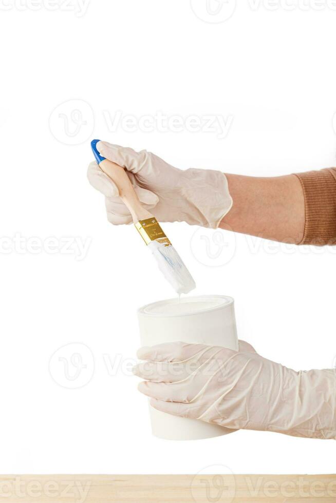 white paint with a brush painting a wooden background with texture photo