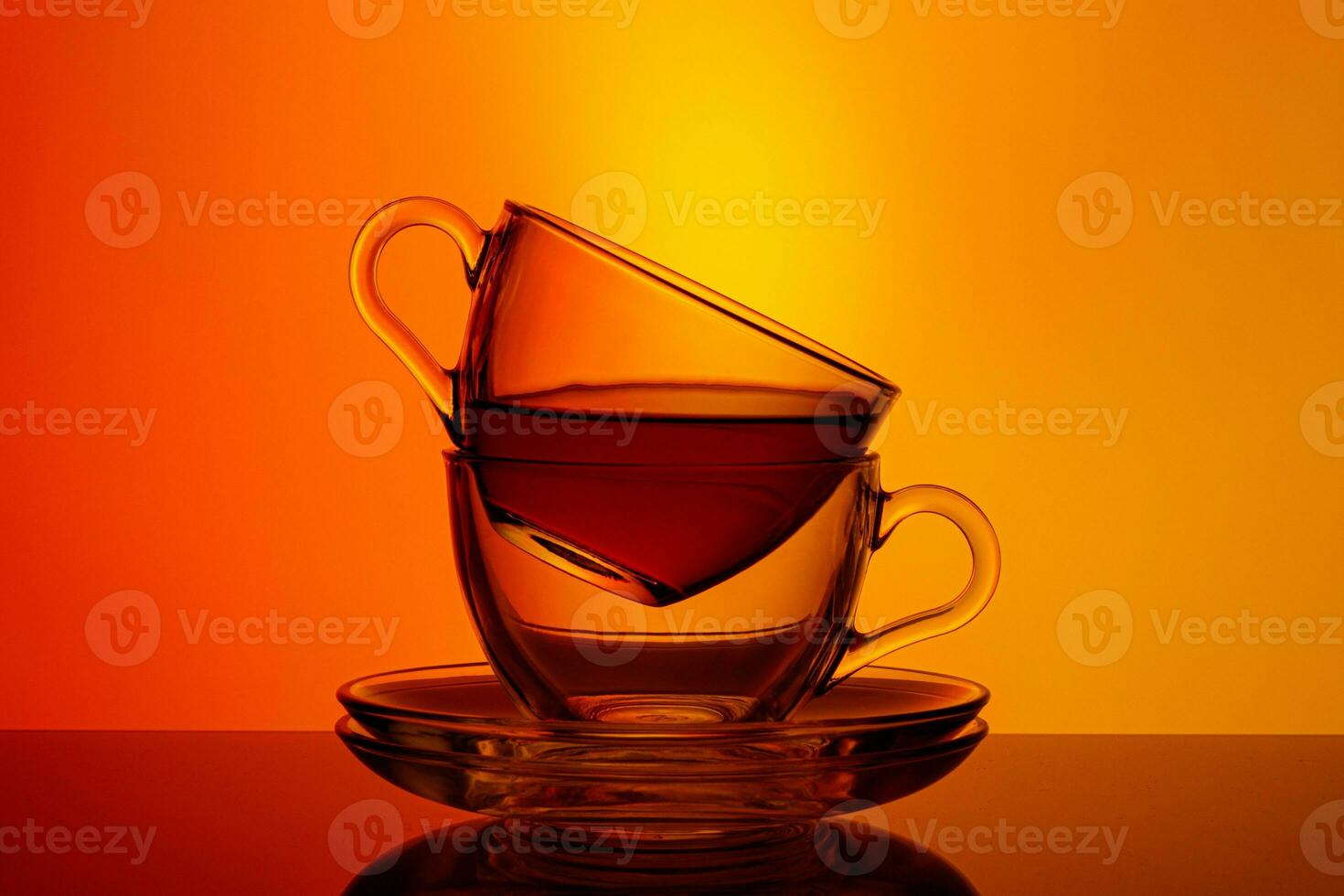 beautiful two cups with tea on an orange and yellow background photo