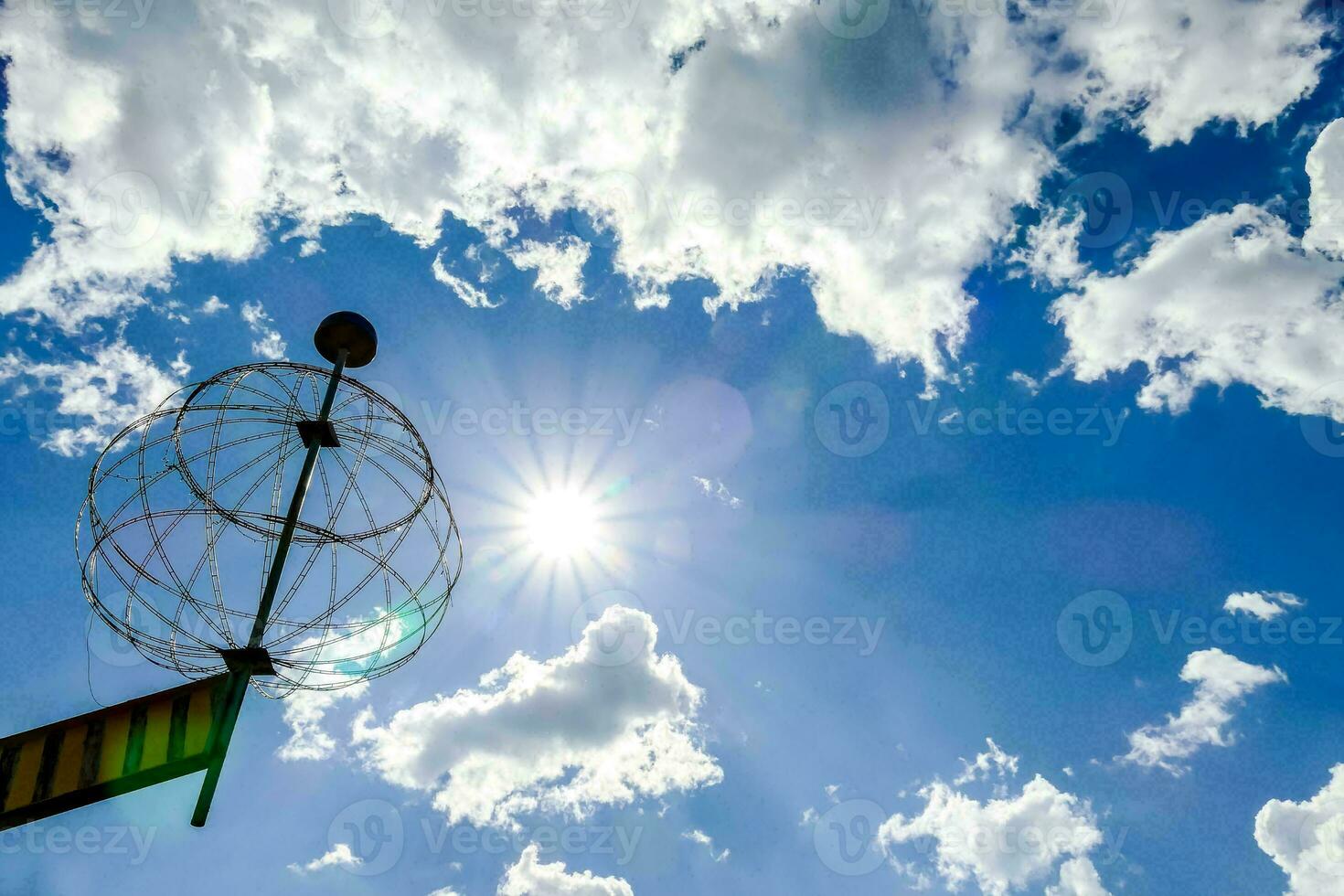 a metal ball with a sun in the sky photo