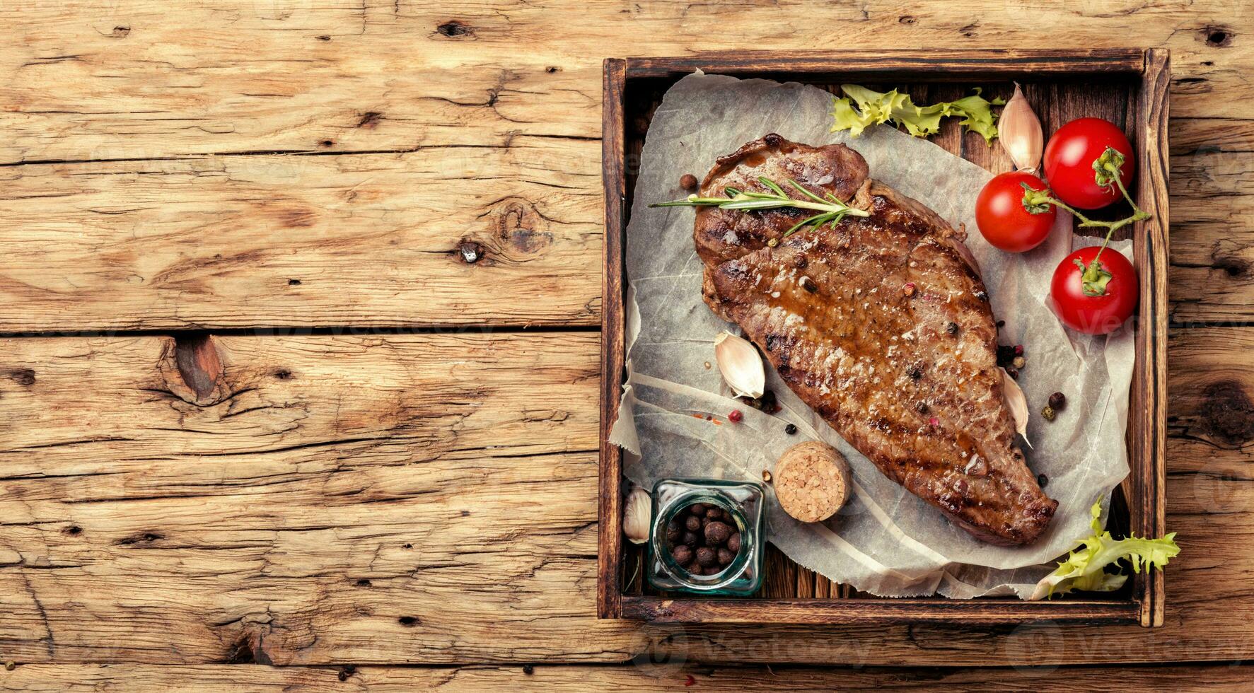 Beef steak on a wooden background photo