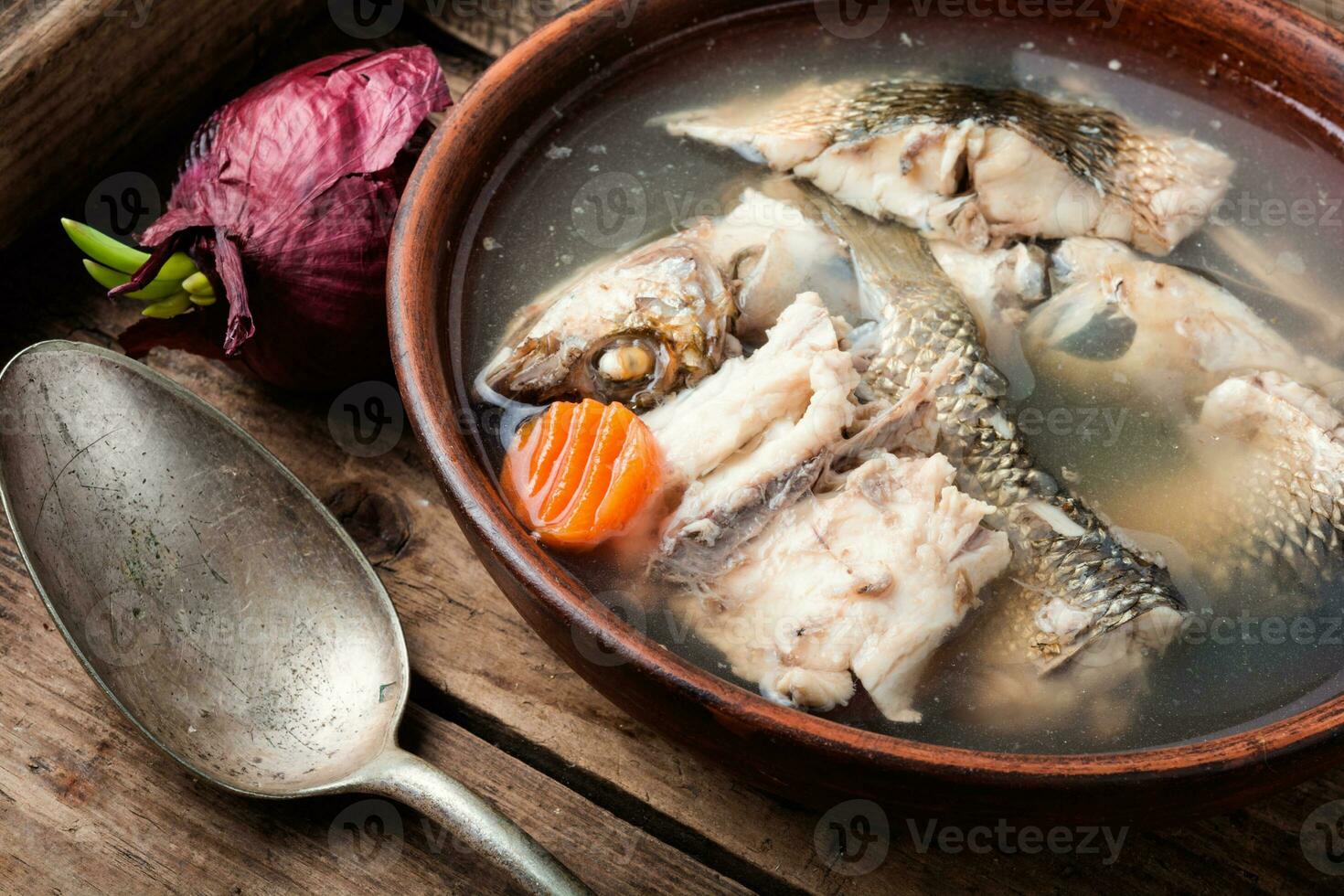 Fish soup in plate photo