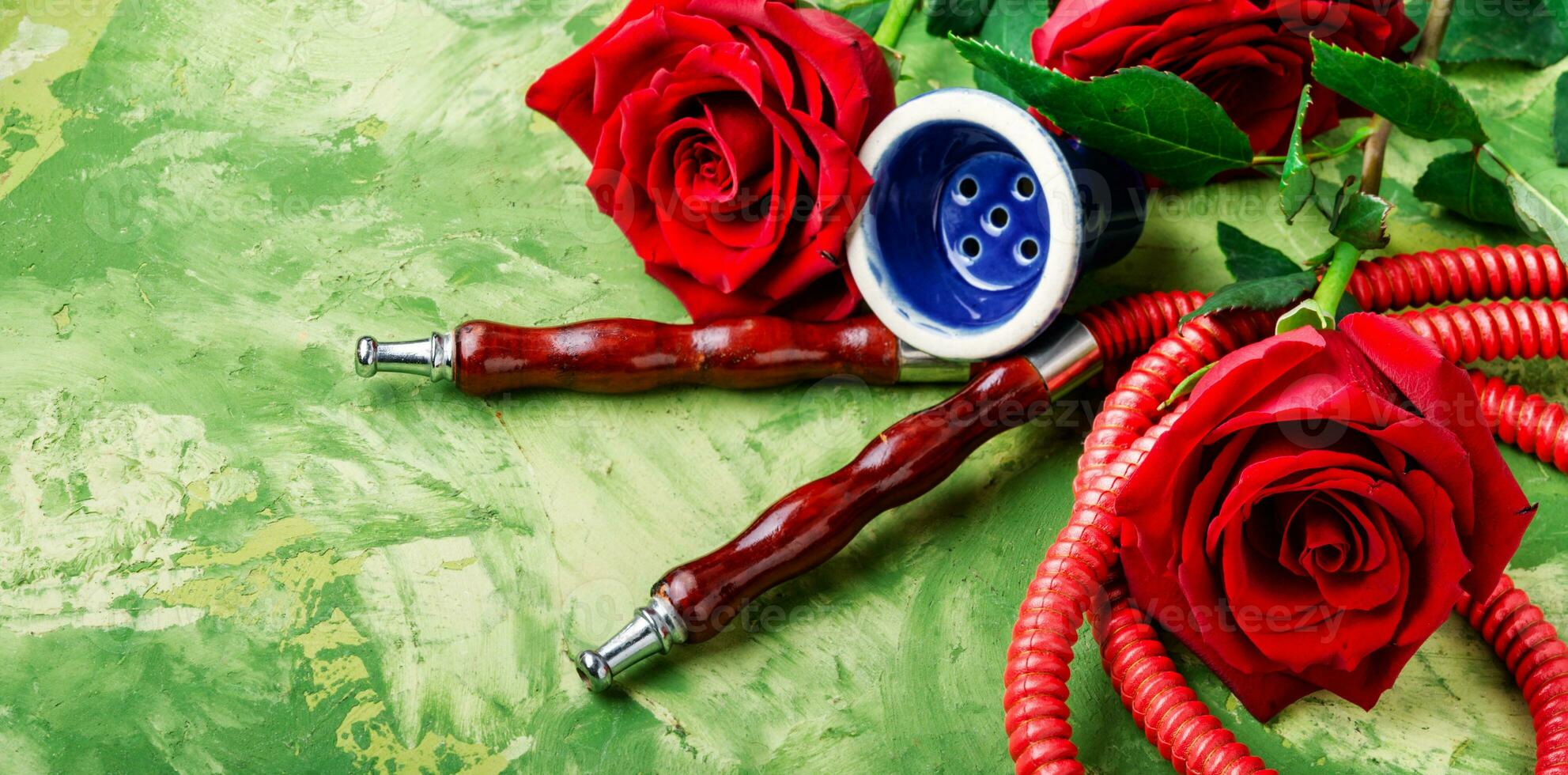 Smoking hookah with rose flavor photo