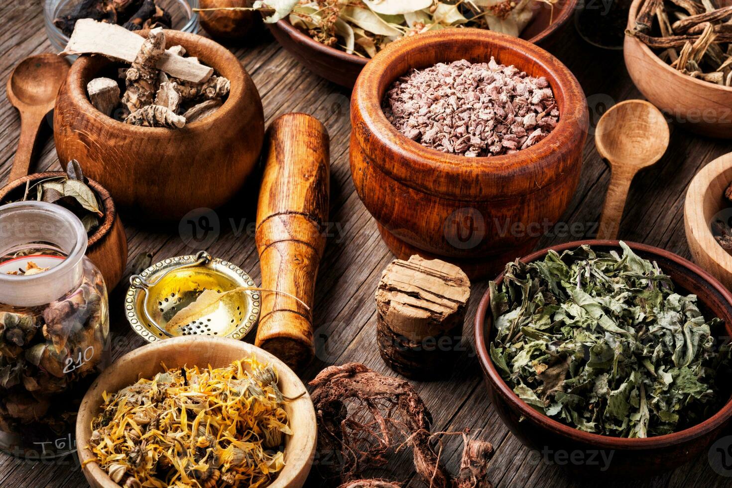 Healing herbs on wooden table photo