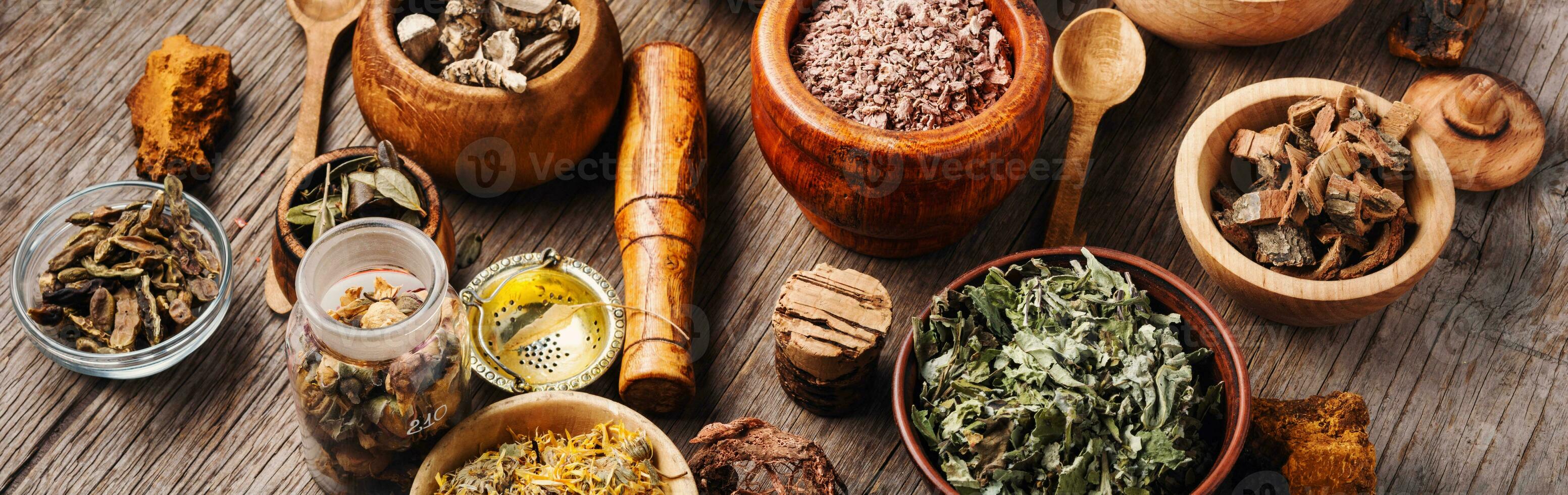 Healing herbs on wooden table photo