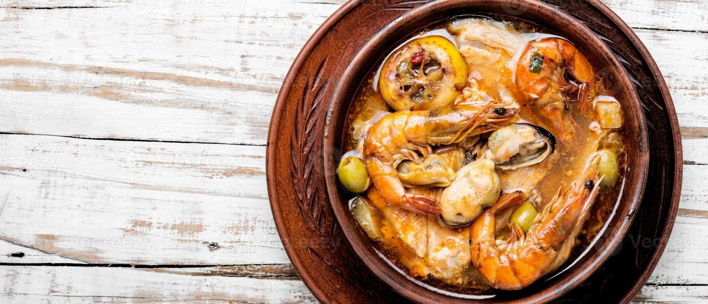 Hot seafood soup with fish photo