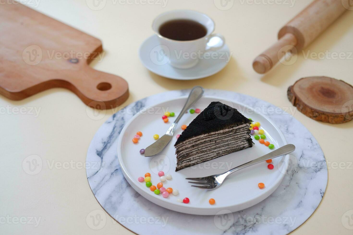 Piece of homemade chocolate crepes cake on a white plate photo