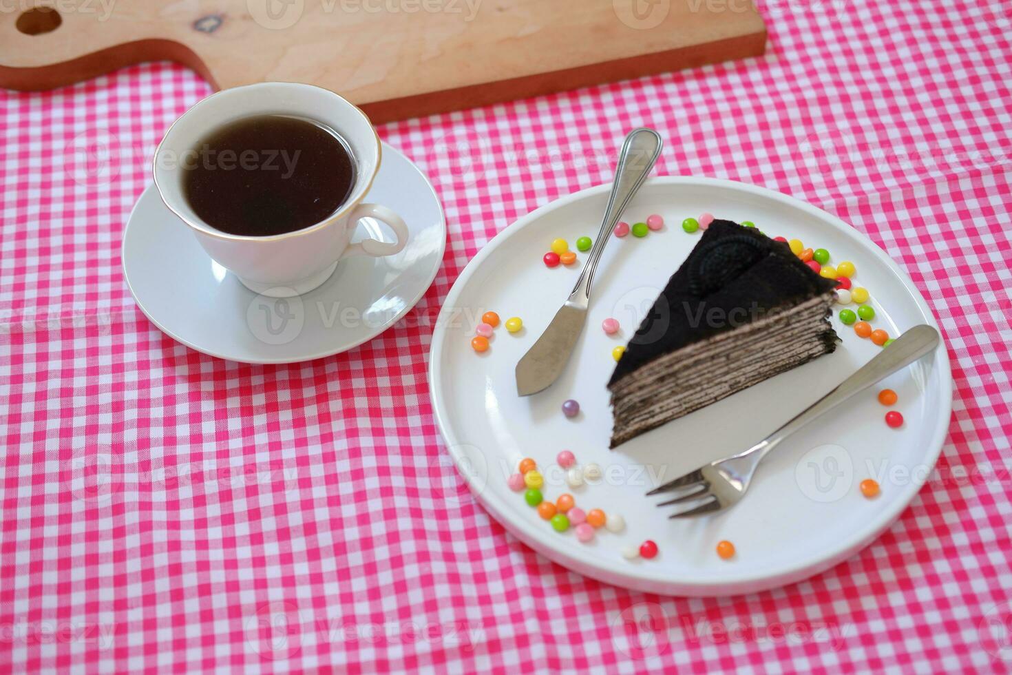 Piece of homemade chocolate crepes cake on a white plate photo