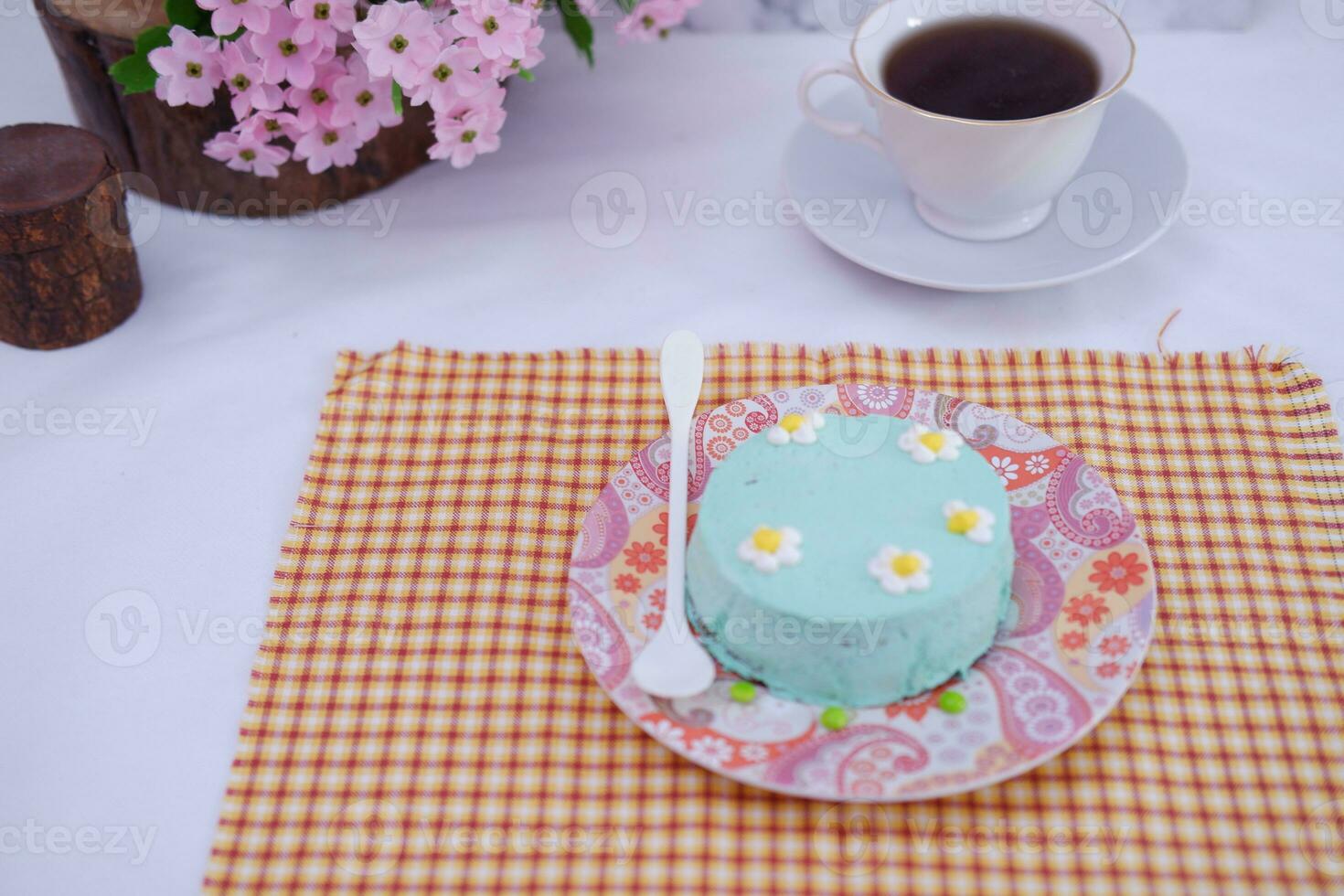 Green tea mousse cake with cup of coffee on the table. photo
