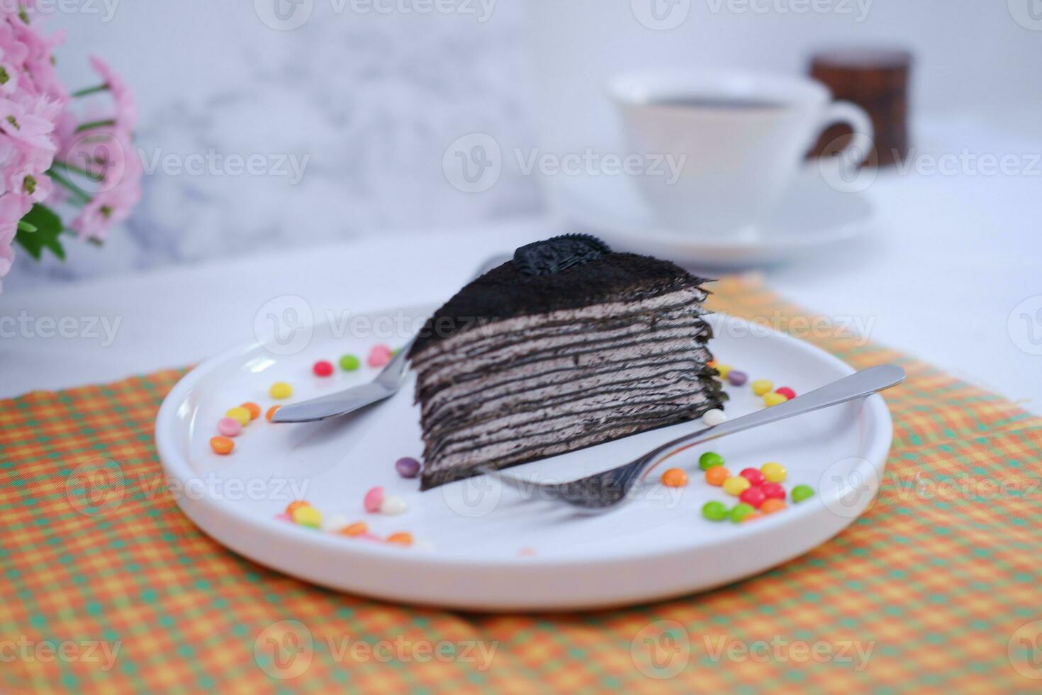 Piece of homemade chocolate crepes cake on a white plate photo