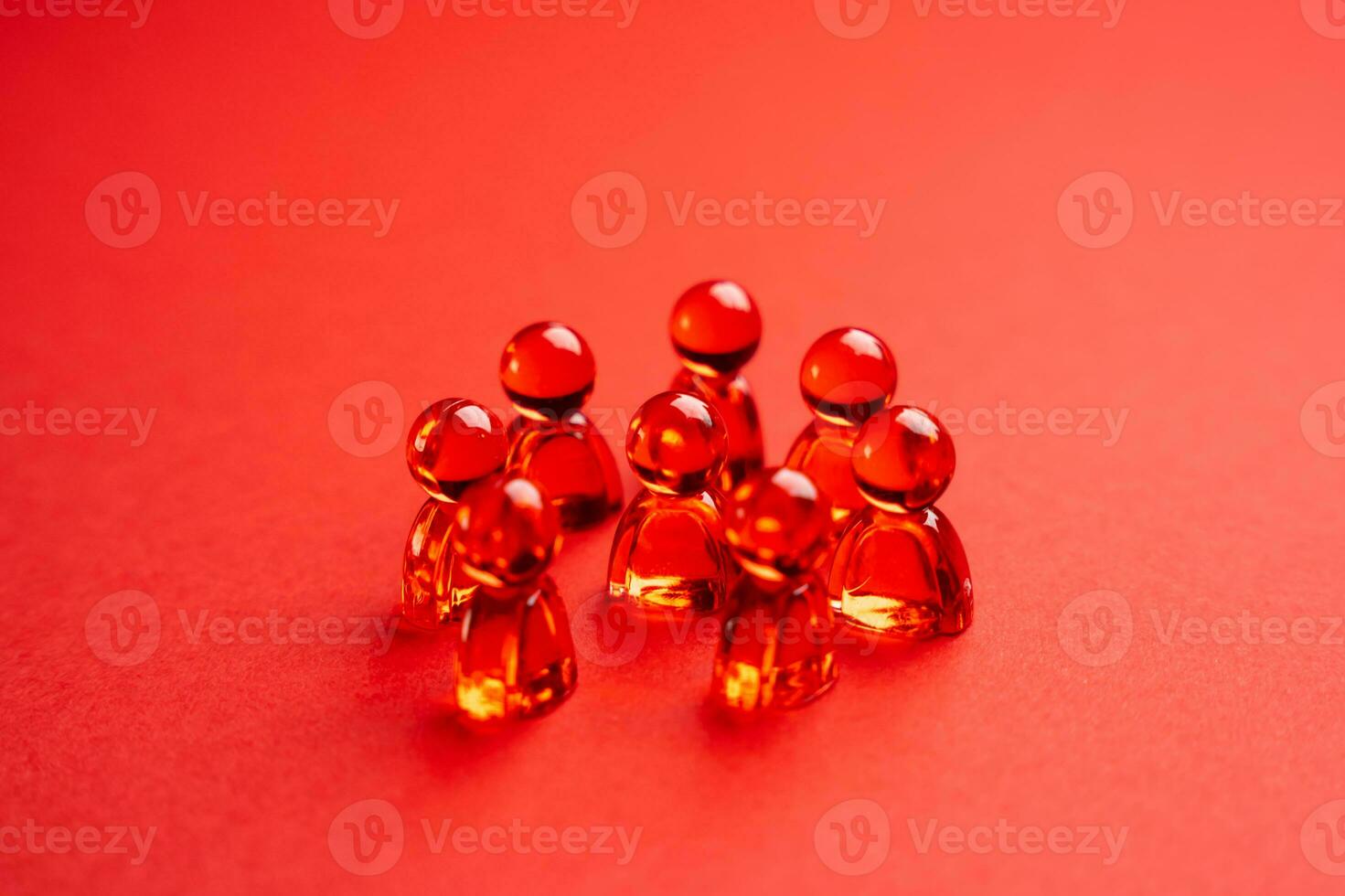 Red glass people figurines. Abstraction. Community or team. photo